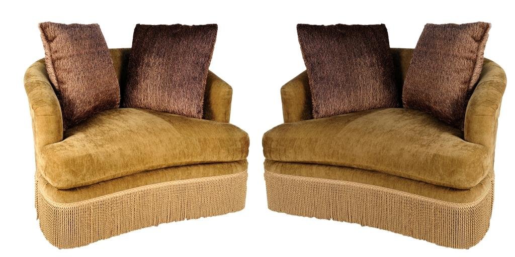 A PAIR OF CHENILLE WINGBACK STYLE SOFA CHAIRS WITH FRIN: A PAIR OF CHENILLE WINGBACK STYLE SOFA CHAIRS WITH FRINGE 20th Century Two taupe colored sofa chairs, large enough for two, features chenille fabric, and a brocade trim with long twist fringe. 31 x 48