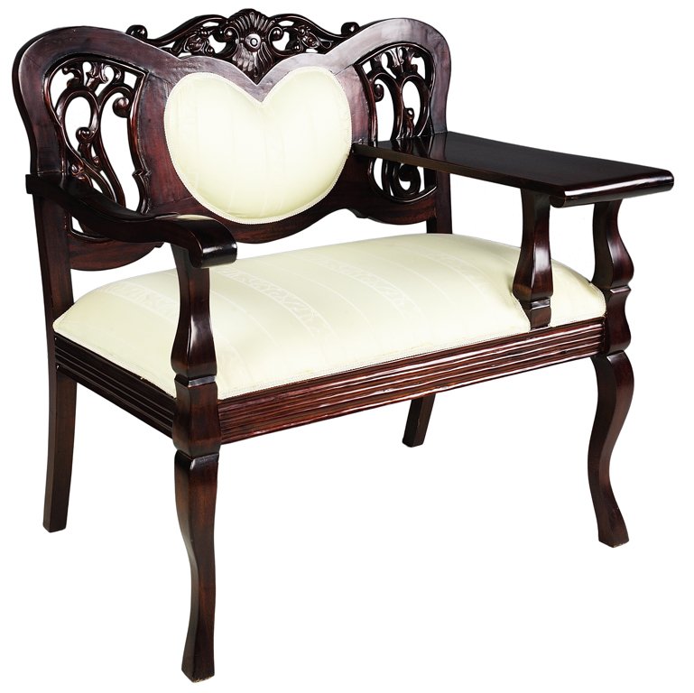 A CARVED MAHOGANY HEART SETTEE WITH WRITING SURFACE Ver: A CARVED MAHOGANY HEART SETTEE WITH WRITING SURFACE 20th Century The hand carved mahogany settee features a padded heart back flanked by pierced scrolling detail and a writing surface. Upholstered in 