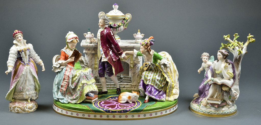 A LARGE DRESDEN STYLE PORCELAIN FIREPLACE SCENE AND TWO: A LARGE DRESDEN STYLE PORCELAIN FIREPLACE SCENE AND TWO FIGURINES 20th Century A large DRESDEN style porcelain fireplace scene, features three aristocrats, seated around the hearth are reading, playin