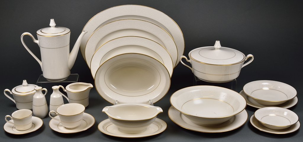 A COLLECTION OF NORITAKE GILT RIM AND IVORY CHINA: A COLLECTION OF NORITAKE GILT RIM AND IVORY CHINA 20th Century A beautiful Noritake gilt rim and ivory china set featuring a coffee service, salt and pepper shakers, vegetable bowl, gravy boat, servin