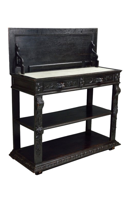 A FRENCH VICTORIAN STYLE CONVERTABLE MARBLE TOP SIDEBOA: A FRENCH VICTORIAN STYLE CONVERTABLE MARBLE TOP SIDEBOARD Late 19th - Early 20th Century, France A French Victorian style ebonized carved convertible sideboard opens from a wood top to reveal a white 