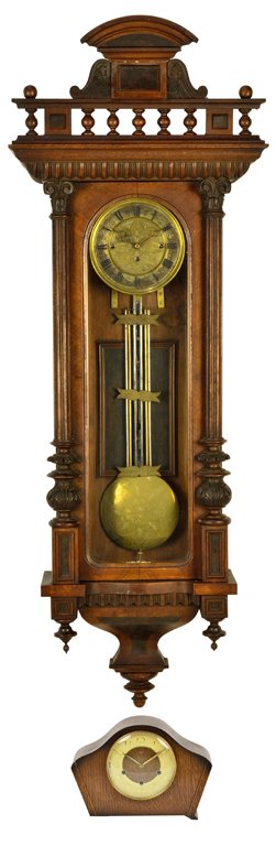 A GROUPING OF A WALNUT WALL CLOCK AND SMITHS MANTEL CLO: A GROUPING OF A WALNUT WALL CLOCK AND SMITHS MANTEL CLOCK A fine walnut wall clock featuring an arched cornice with spandrel below, with antique dial and long pendulum flanked by tapered and turned co