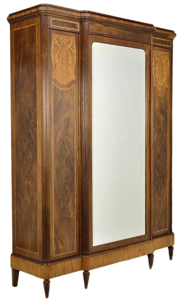 AN ART NOUVEAU STYLE PARQUETRY ARMOIRE: AN ART NOUVEAU STYLE PARQUETRY ARMOIRE Early 20th Century, France An Art Nouveau style three door armoire having a stepped cornice with walnut banding, an inlaid frieze, having a larger stepped center