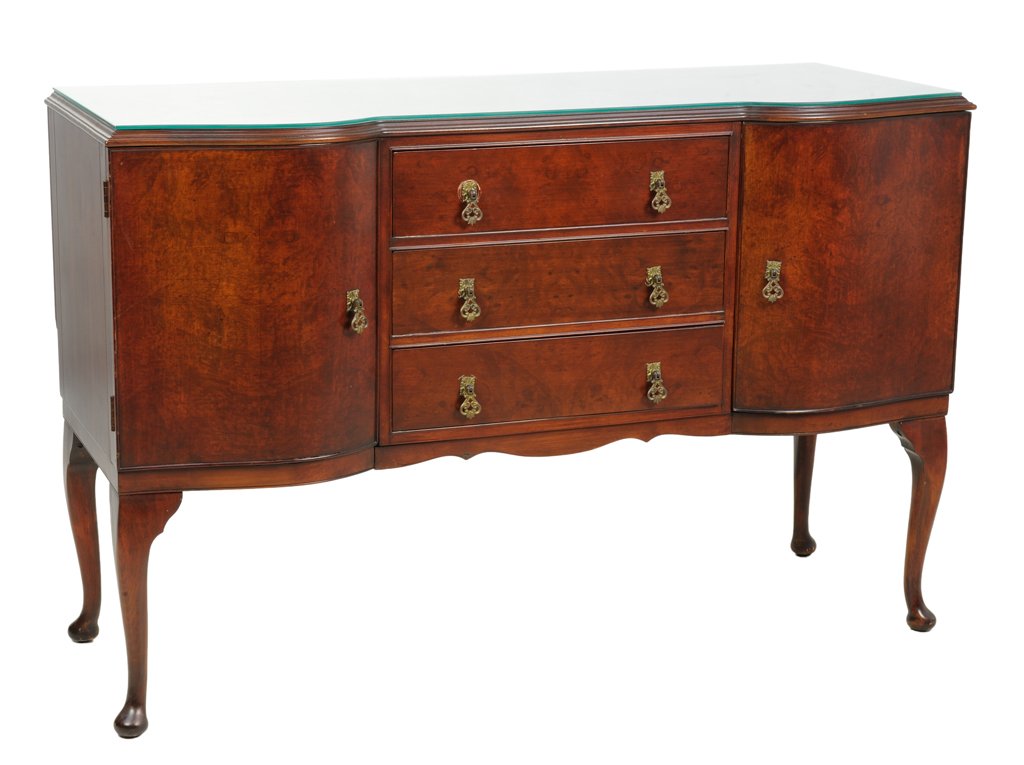 A VINTAGE QUEEN ANNE STYLE SIDEBOARD WITH GLASS TOP: A VINTAGE QUEEN ANNE STYLE SIDEBOARD WITH GLASS TOP Mid-20th Century A vintage Queen Anne style sideboard features a glass top, three center drawers are flanked by two panel doors, having a shaped apr