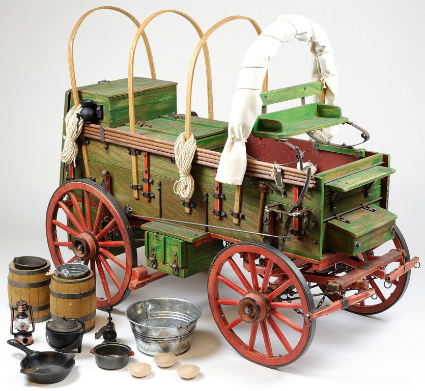 A MINIATURE SCALE MODEL OF A 1906 JOHN DEERE STYLE COVE: A MINIATURE SCALE MODEL OF A 1906 JOHN DEERE STYLE COVERED COWBOY CHUCK WAGON Early-Mid 20th Century, USA A unprecedented, scale model of a 1906 JOHN DEERE style chuck wagon is hand painted red and gr