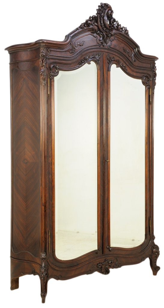 A LOUIS XV STYLE ROSEWOOD ARMOIRE: A LOUIS XV STYLE ROSEWOOD ARMOIRE Late 19th - Early 20th Century, France The shaped, arched cornice is highlighted by exquisitely carved, scrolling acanthus leaves surmounting two doors featuring beve