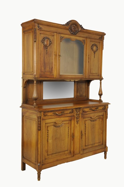 A LOUIS XVI STYLE CHESTNUT AND WALNUT BUFFET: A LOUIS XVI STYLE CHESTNUT AND WALNUT BUFFET Early 20th Century The arched crest is highlighted by a shell motif with c-scrolls and a floral swag surmounting an upper cabinet with a beveled glass lock