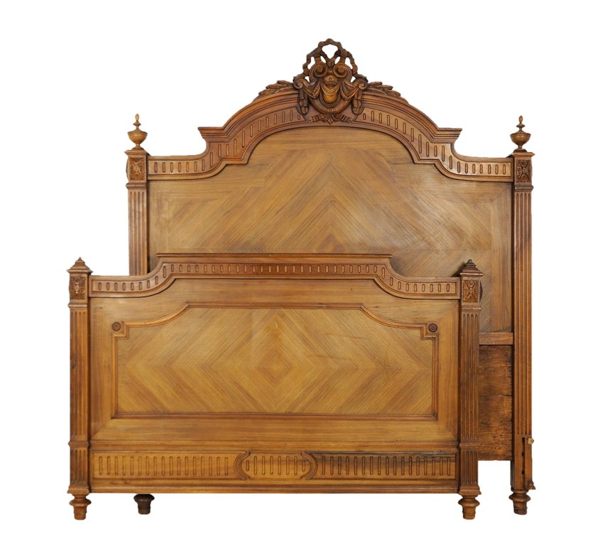AN ANTIQUE LOUIS XVI STYLE DIAMOND PARQUETRY WALNUT BED: AN ANTIQUE LOUIS XVI STYLE DIAMOND PARQUETRY WALNUT BED Early 20th Century, France An antique Louis XVI style walnut bed is crowned by a pierced festooned swag arch, with reed carved freize, a diamon 