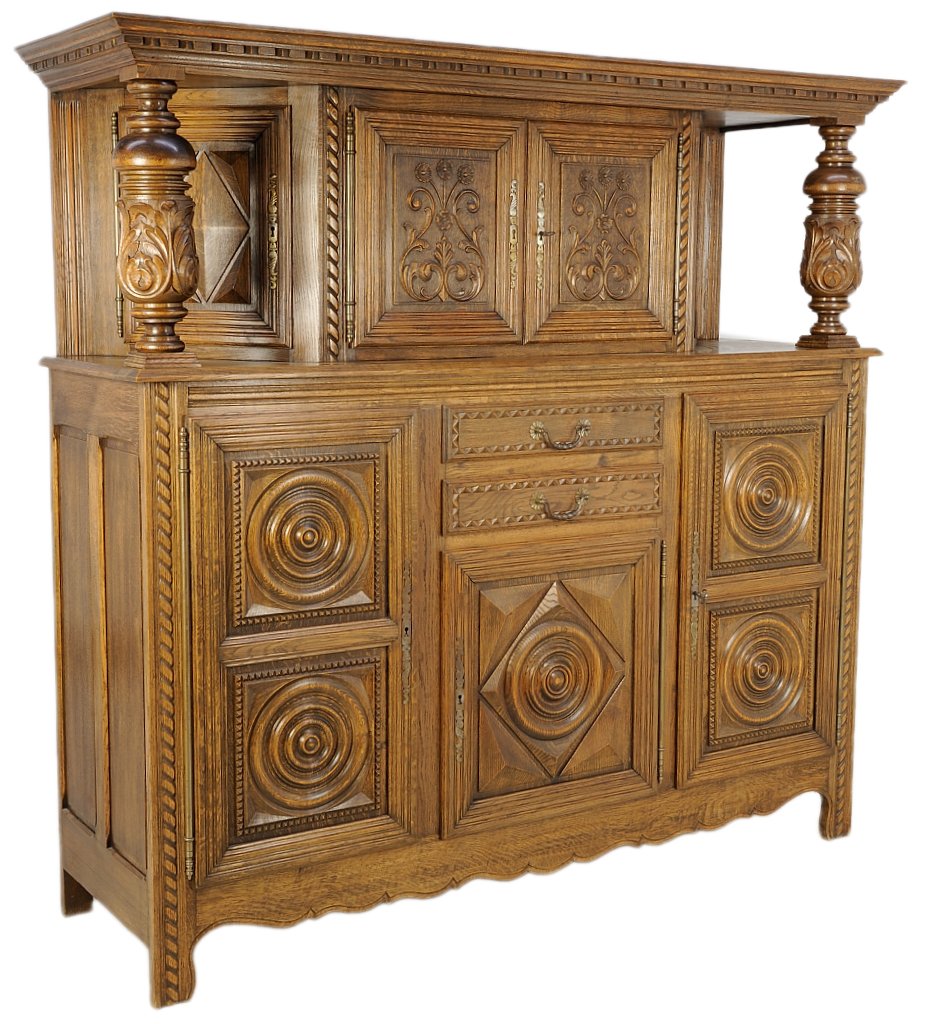 AN ANTIQUE LOUIS XIII STYLE FRENCH ROUNDEL LOZENGE BUFF: AN ANTIQUE LOUIS XIII STYLE FRENCH ROUNDEL LOZENGE BUFFET OAK CUPBOARD Early 20th Century, France The stepped cornice with recessed, conforming oak body is supported by three upper cabinets with four 