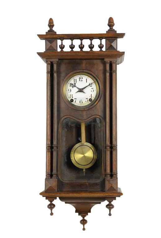 A VICTORIAN STYLE WALNUT WALL CLOCK: A VICTORIAN STYLE WALNUT WALL CLOCK The wall clock featuring spindle balustrade and double engaged columns; includes rod chime, pendulum, and key. 34 x 14 x 8 inches