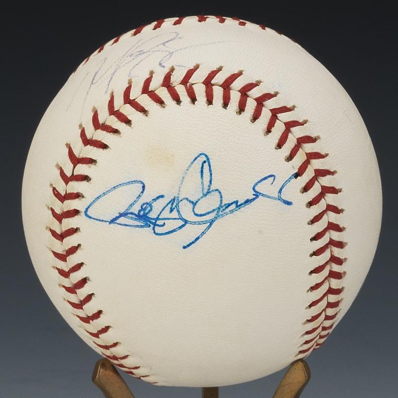 Roger Clemens and Mike Piazza Autographed Baseball: OLM Selig ball with blue pen signatures of Roger Clemens on the panel and Mike Piazza on the sweet spot, in a plexiglass case, Letter of Authenticity from Global Authentication included. View and Bid