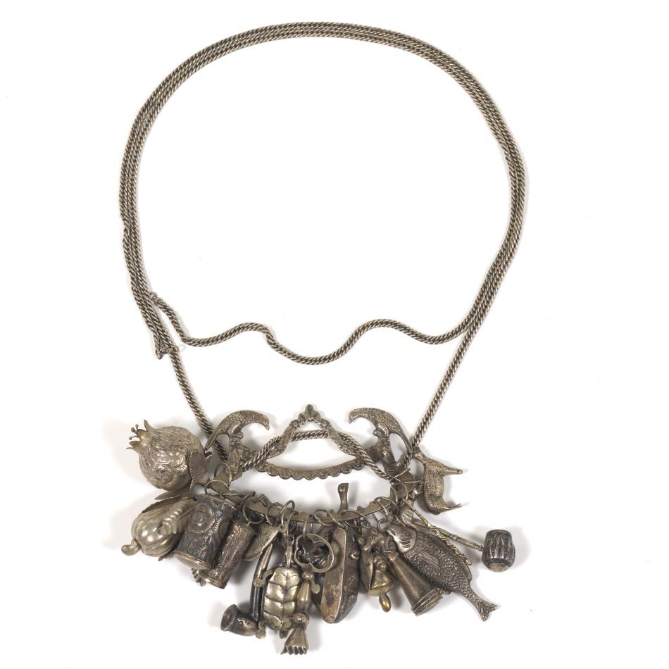 Brazilian Antique Penca de Balangandan Silver/Silver: 6" x 9" overall with 64" chain Historic antique silver/silver plate 21 slave amulets, fashioned as different fruits, vegetables and objects, attached with silver plate cast handle decorated with folia