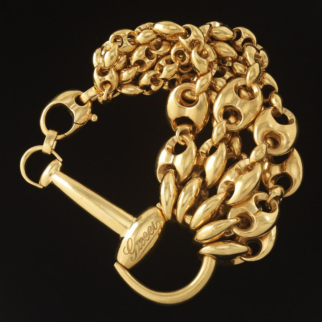 Gucci 18k Gold Horsebit Bracelet: 18k yellow gold bracelet designed as a large horsebit section, attached five graduated link bracelets; overall weight 81.5 gm.