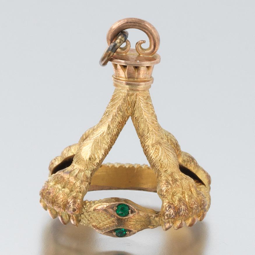English Edwardian Gold Serpent Held by Lion Paws Pocket: 1-1/4" x 15/16" x 3/4" 9k rose-yellow gold well made pocket watch fob, fashioned as an open work coiled serpent with round cut emerald eyes, held by four lion clawed paws, textured finish, oval apertu