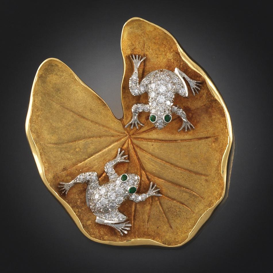 McTeigue & Co 18k Gold and Platinum Lily Pad Brooch: 2"L x 1-Â¾"W 18k and platinum brooch in the shape of a lily pad with a textured matte finish, and features two platinum frogs, pave set diamonds, 1.00-carat total weight, eyes set with round