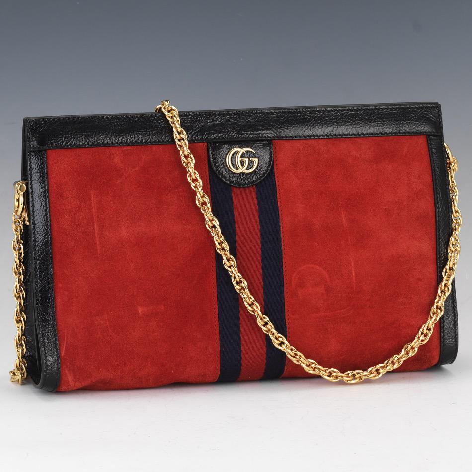 Gucci Medium Ophidia Shoulder Bag in Red Suede: 8" x 13" x 3-1/2" Red calfskin suede bag with black leather trim, GG gold toned hardware, blue satin lining, double gusset, interior open pocket to one side with zipper pocket at the other, gold chain
