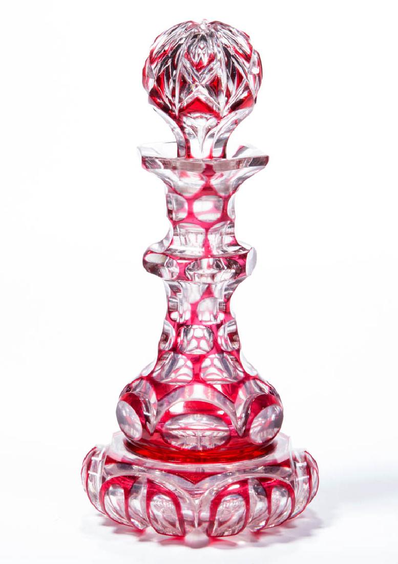 CUT OVERLAY PUNTY, VESICA, AND LEAF COLOGNE BOTTLE: CUT OVERLAY PUNTY, VESICA, AND LEAF COLOGNE BOTTLE, rose to colorless, skirted baluster form with neck ring, factory-polished hexagonal mouth, and rosette-cut base, original globular air-trap stopper.