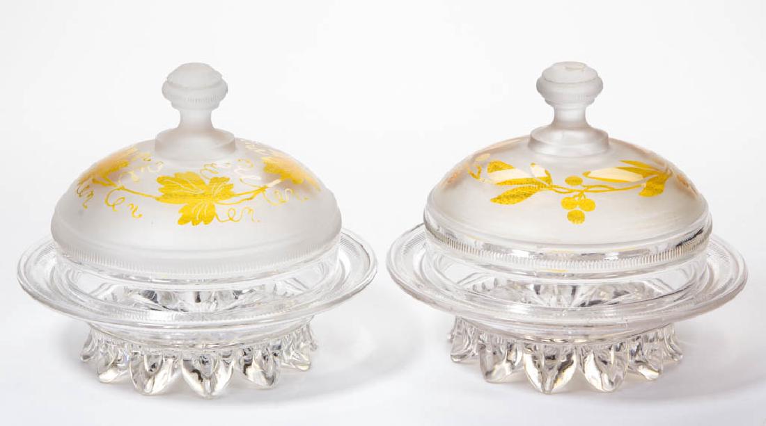 DUNCAN NO. 89 / RIBBED DROPLET BAND - AMBER-STAINED: DUNCAN NO. 89 / RIBBED DROPLET BAND - AMBER-STAINED BUTTER DISHES, LOT OF TWO, frosted colorless, each with a varying foliate decoration. Geo. Duncan & Sons. Circa 1886. 5 3/4" HOA. Berry and Vine exa