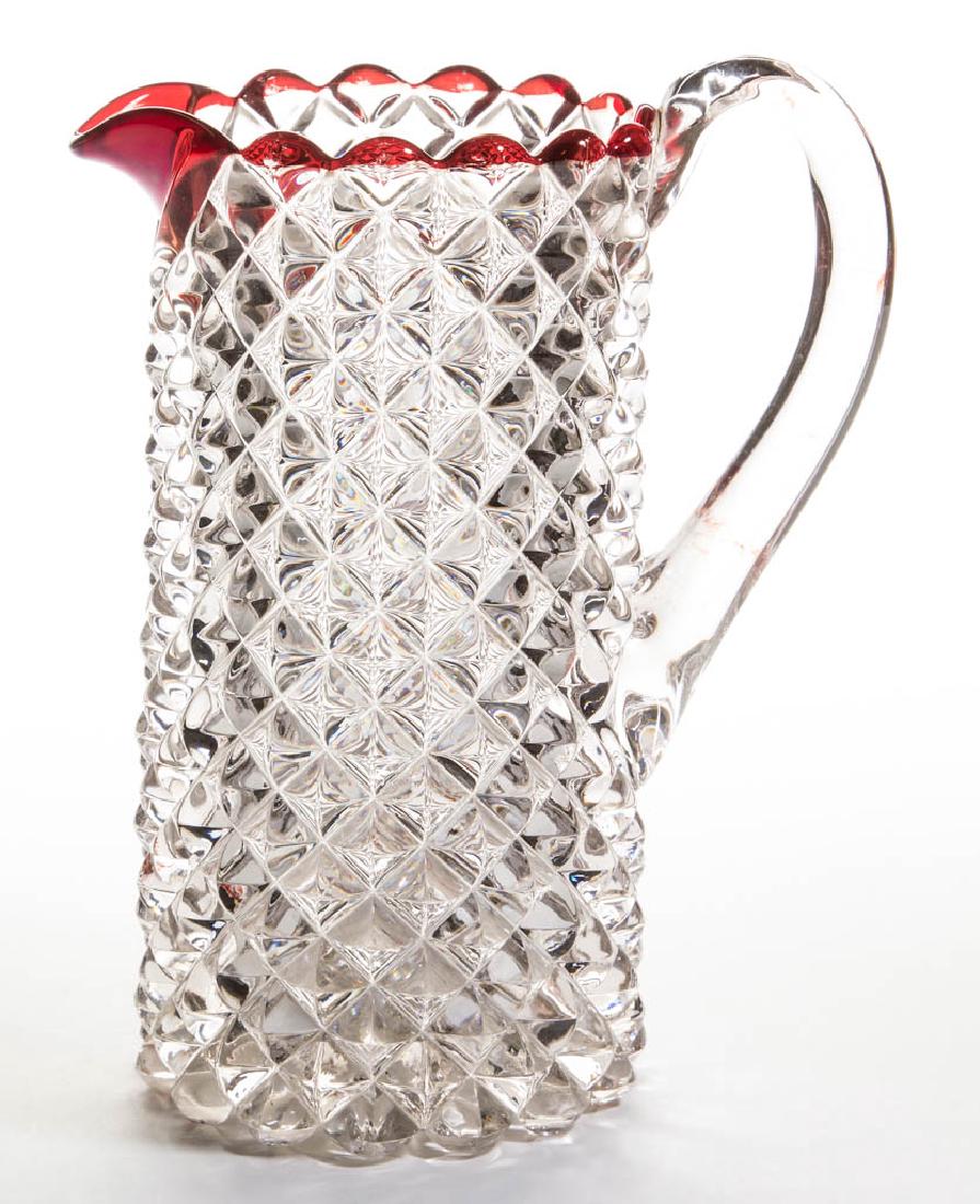 ROANOKE - RUBY-STAINED WATER PITCHER: ROANOKE - RUBY-STAINED WATER PITCHER, colorless, tankard form with applied handle, stained to rim. Ripley & Co. 1888-1898. 10" H. Undamaged. Literature: Parallels Heacock - Book 7: Ruby-Stained Glass 