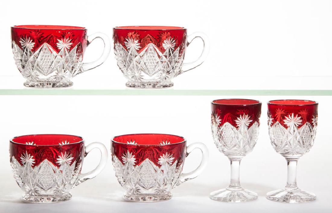 WESTMORELAND'S STERLING - RUBY-STAINED DRINKING: WESTMORELAND'S STERLING - RUBY-STAINED DRINKING ARTICLES, LOT OF SIX, colorless, comprising two wines and four punch cups. Westmoreland Glass Company. Circa 1896. 3 3/4" H wine, 2 1/4" H punch cups.On