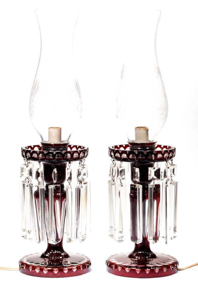 BOHEMIAN CUT OVERLAY PAIR OF ELECTRIC MANTLE LUSTERS: BOHEMIAN CUT OVERLAY PAIR OF ELECTRIC MANTLE LUSTERS, deep ruby to colorless, each with single socket, engraved chimney/shade, and coffin prisms. Mid 20th century. 17" HOA.Undamaged.