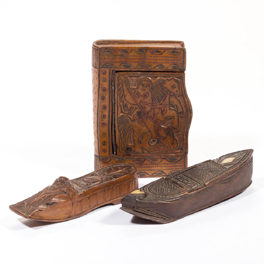 ASSORTED CARVED WOOD SNUFF / MATCH BOXES, LOT OF THREE: ASSORTED CARVED WOOD SNUFF / MATCH BOXES, LOT OF THREE, comprising one book form and two shoe form, each with hinged lid, one with bone inlay. 19th century. Book 2 1/2" x 4". Inlaid example with loose