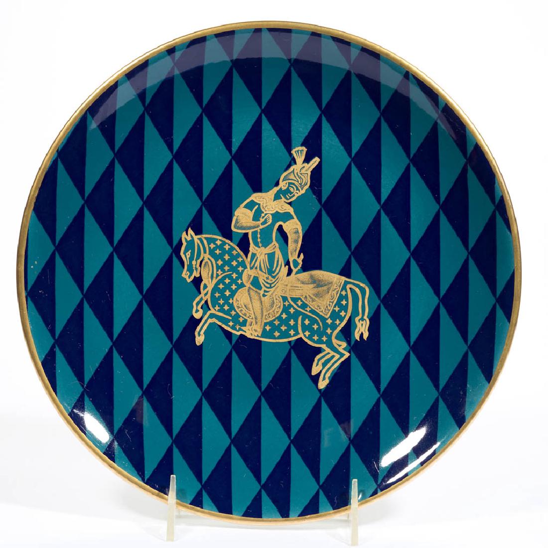 SHENANGO PERSIAN ROOM HOTEL NEW YORK PLATE: SHENANGO PERSIAN ROOM HOTEL NEW YORK PLATE, with dark blue and teal triangular pattern on front with gilt rim and gilt figure on a horse design in center made for the "Persian Room" at the Plaza Hotel