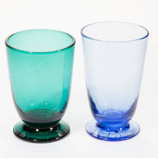 EARLY BLENKO GLASS FOOTED TUMBLERS, LOT OF TWO: EARLY BLENKO GLASS FOOTED TUMBLERS, LOT OF TWO, pale blue and teal, each signed, "BLENKO/1938". Possibly made by Carl Ebert Erickson. 1938. 4 3/4" to 5" H.Teal undamaged, blue with several annealing