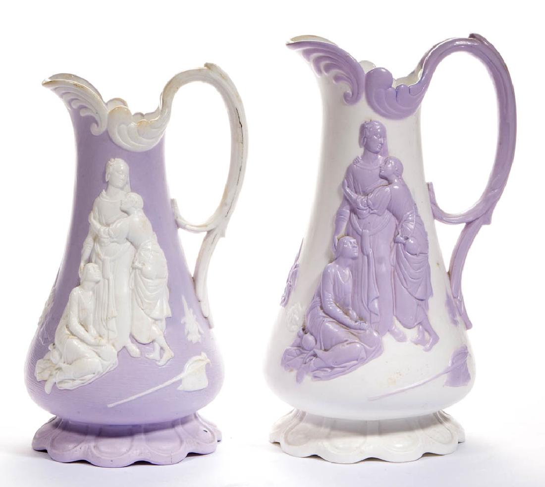 ENGLISH PARIAN SMEAR GLAZE NAOMI CERAMIC PITCHERS, LOT: ENGLISH PARIAN SMEAR GLAZE NAOMI CERAMIC PITCHERS, LOT OF TWO, both with molded flared base, baluster form, and the design of "Naomi and her Daughters-in-Law" as marked on base, one with lavender body