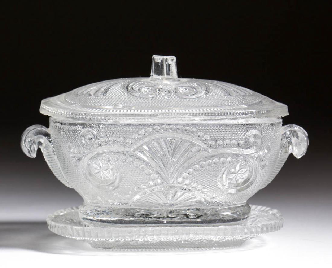 PRESSED LACY LARGE TOY TUREEN, COVER, AND UNDERTRAY: PRESSED LACY LARGE TOY TUREEN, COVER, AND UNDERTRAY, colorless, various fan, lily, scroll, star, and diamond design elements, molded handles. Boston & Sandwich Glass Co. 1835-1850. 2 3/4" HOA, 2 3/4" 