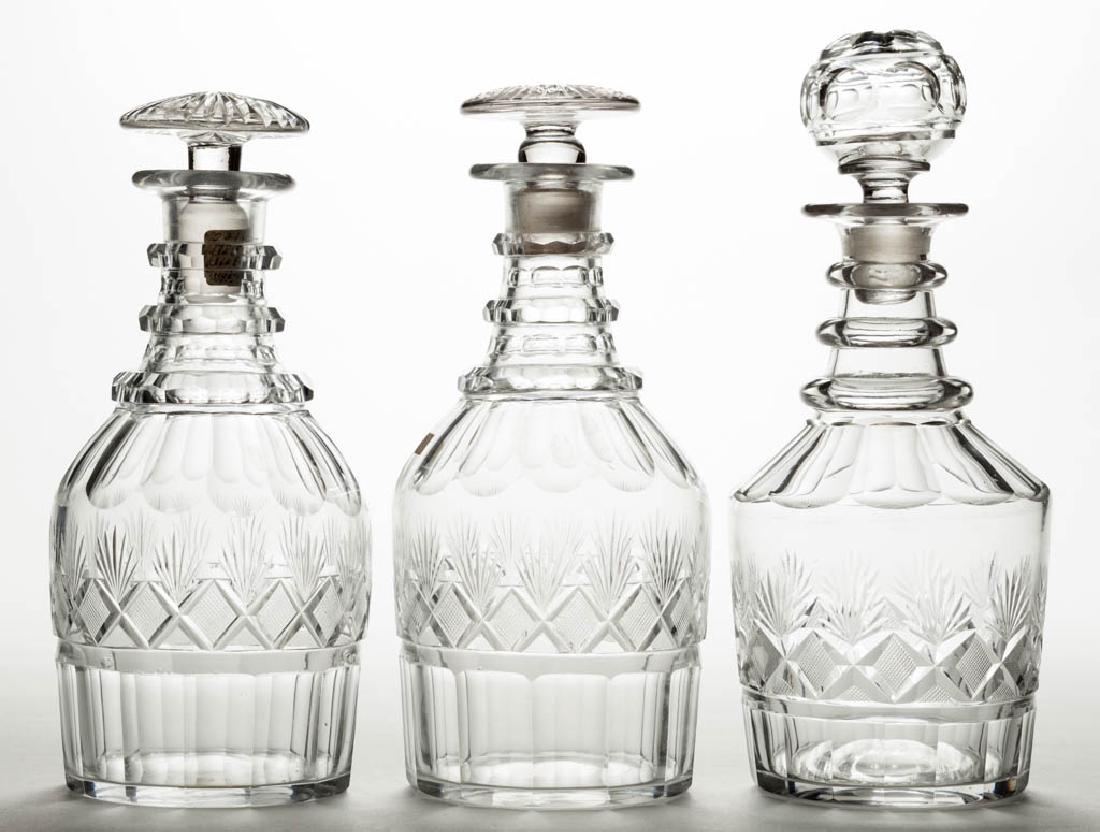 CUT STRAWBERRY DIAMOND AND FAN QUART DECANTERS, LOT OF: CUT STRAWBERRY DIAMOND AND FAN QUART DECANTERS, LOT OF THREE, colorless, Prussian and cylindrical forms, two with three cut-facet neck rings, other with three plain neck rings, plain bases with polish