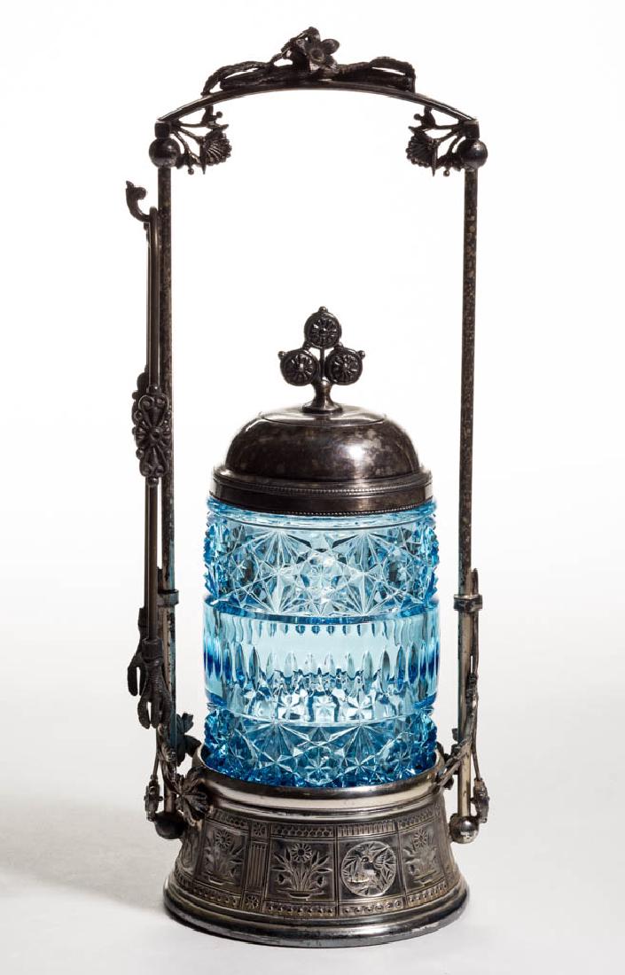 CLIO / DAISY AND BUTTON WITH ALMOND BAND PICKLE CASTER: CLIO / DAISY AND BUTTON WITH ALMOND BAND PICKLE CASTER, blue, fitted in a quadruple-plate stand marked for "MERIDEN" and numbered "206", with tongs and cover. Challinor, Taylor & Co. Circa 1885. Chall