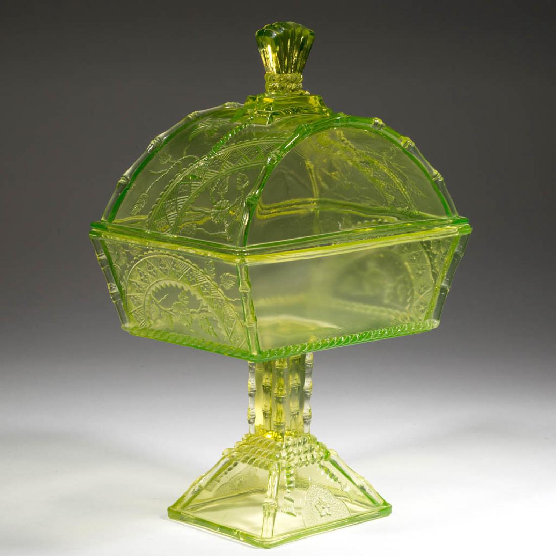 JAPANESE / GRACE VARIANT COMPOTE: JAPANESE / GRACE VARIANT COMPOTE, Vaseline (black lighted), rectangular bowl and high standard. Circa 1880. 12" HOA, 5 1/4" x 8". Virtually undamaged with a minor bruise to the top of the stem, flake 