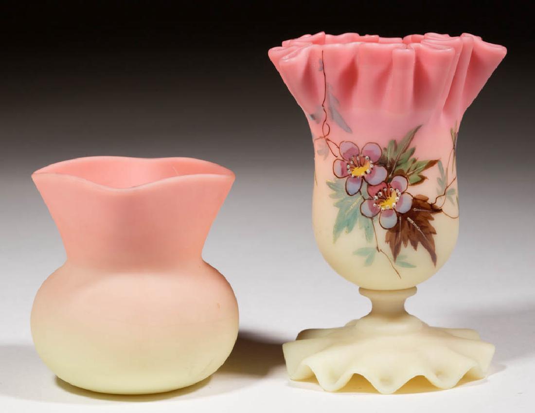 WEBB BURMESE VASES, LOT OF TWO: WEBB BURMESE VASES, LOT OF TWO, plush, comprising a bulbous example with square-top, and an enamel-decorated example with a ruffled rim and tooled foot. Thomas Webb & Sons. 1886-1895. 2 5/8" to 4 1/8"