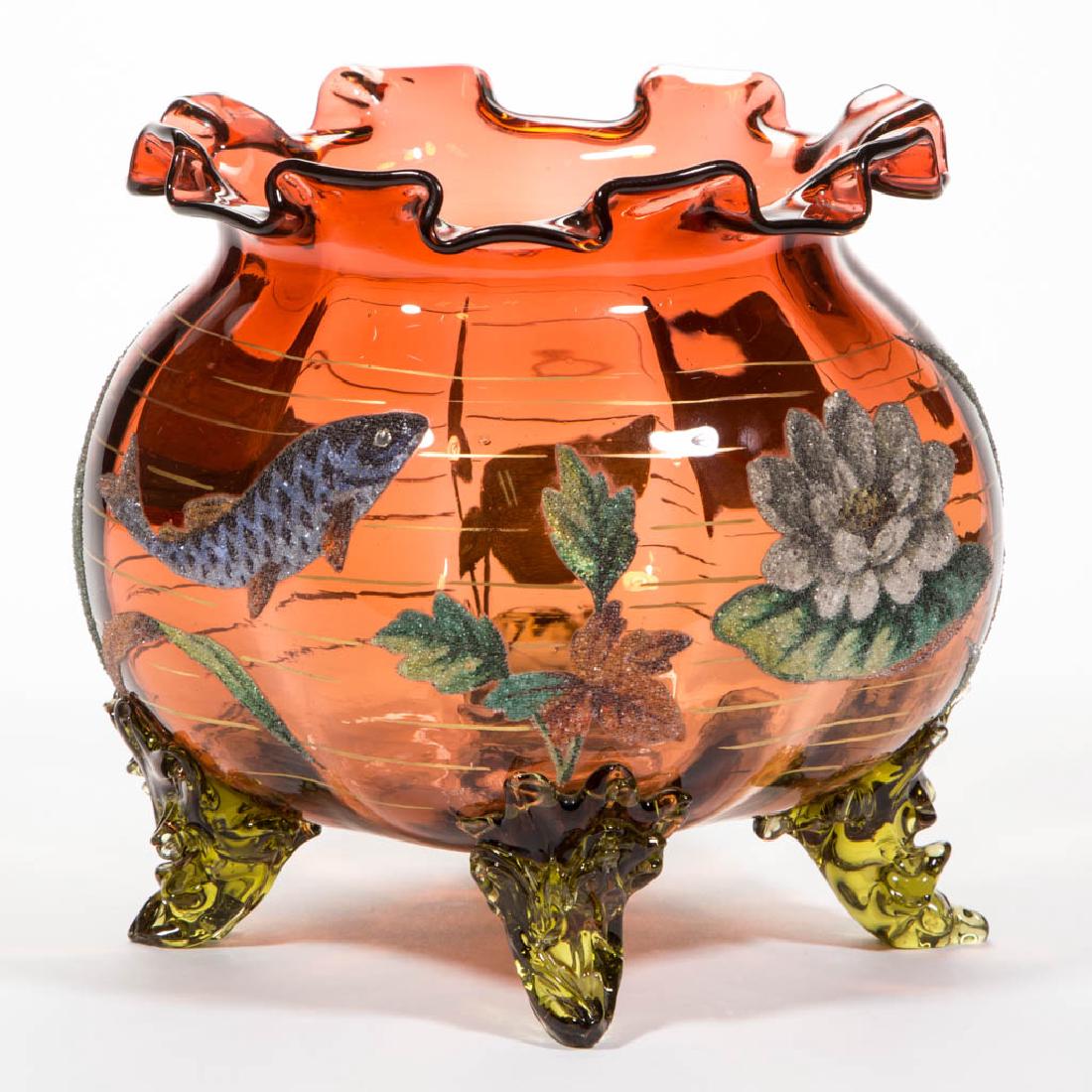 AMBERINA CORALENE-DECORATED FOOTED BOWL: AMBERINA CORALENE-DECORATED FOOTED BOWL, keyed rim, ornate decoration depicting a pond scene with a fish, blooming lily pads, and blades of grass, polished pontil mark with "PATENT" written in the cen