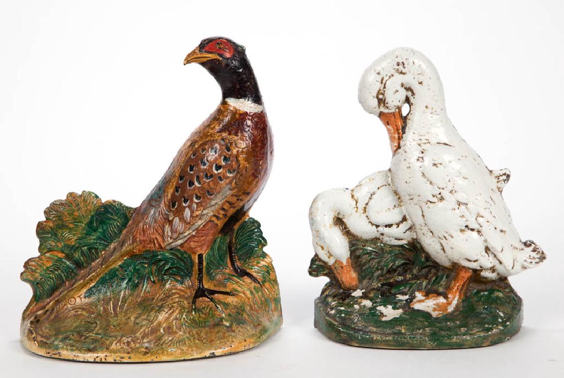FIGURAL CAST-IRON DOORSTOPS, LOT OF TWO: FIGURAL CAST-IRON DOORSTOPS, LOT OF TWO, one pheasant marked "458" to reverse and one pair of ducks marked "CN / 67" to reverse. Each flat-back, hollow form with old painted surface. Circa 1930. 8" an