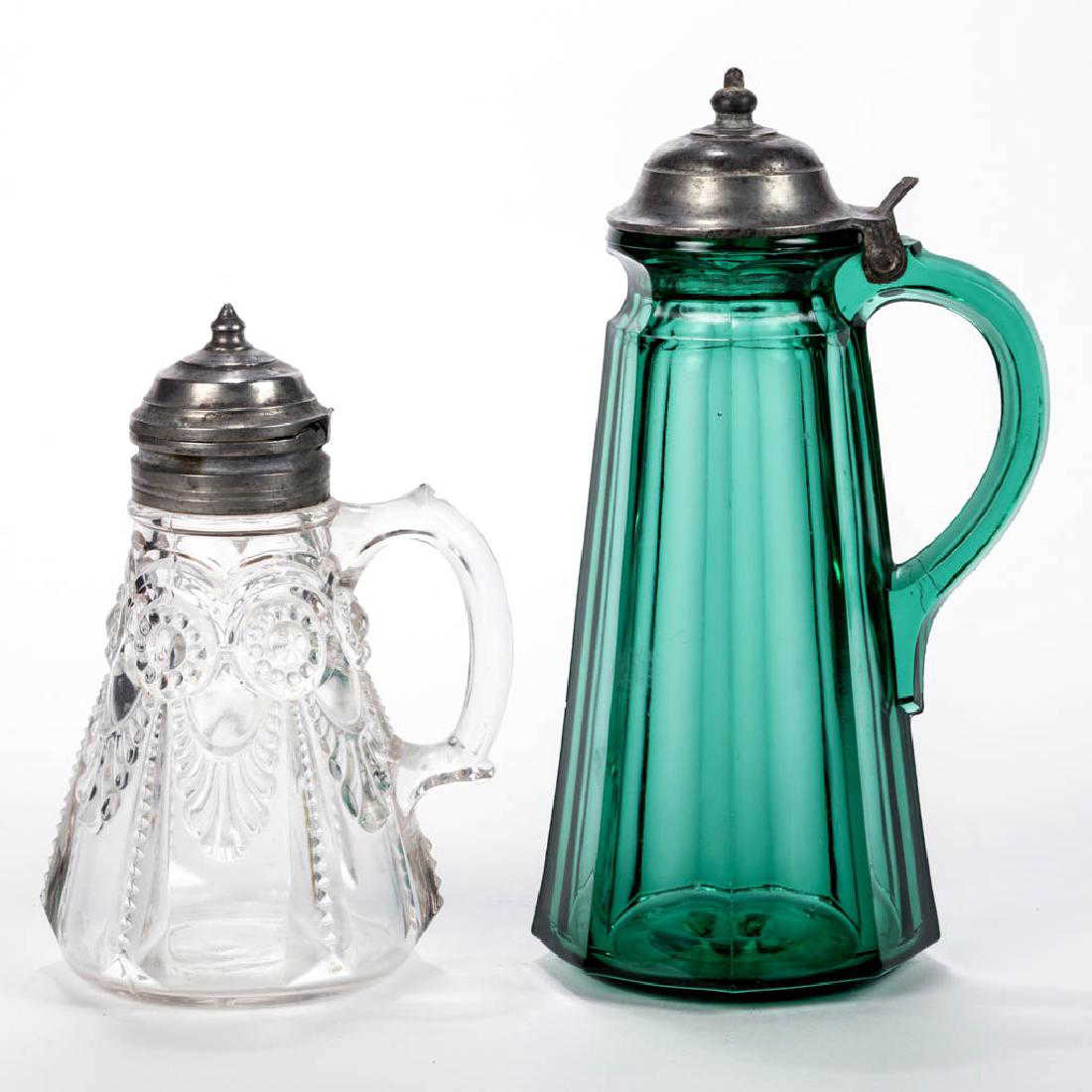 PRESSED GLASS SYRUP PITCHERS LOT OF TWO PRESSED GLASS SYRUP PITCHERS LOT OF TWO