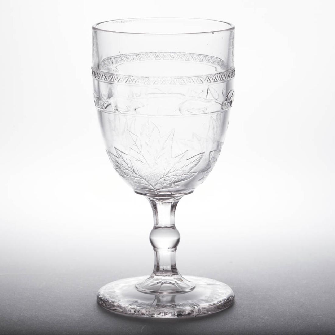 BEAVER BAND GOBLET: BEAVER BAND GOBLET, colorless, "ST. JEAN BAPTISTE. / QUEBEC 24 JUNE 1880." block lettering under foot. Excelsior Glass Co., Quebec. Circa 1880. 5 5/8" H. Undamaged. Literature: Metz - Much More Early 