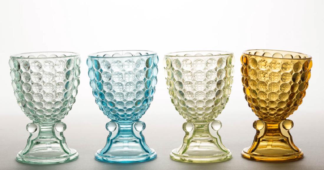 THOUSAND EYE / ADAMS NO. 130 EGG CUPS, LOT OF FOUR: THOUSAND EYE / ADAMS NO. 130 EGG CUPS, LOT OF FOUR, amber, blue, apple green, and Vaseline (black lighted). Adams & Co. Circa 1891. 4 1/8" H.Apple green with a minute pattern bruise, remainder undamag