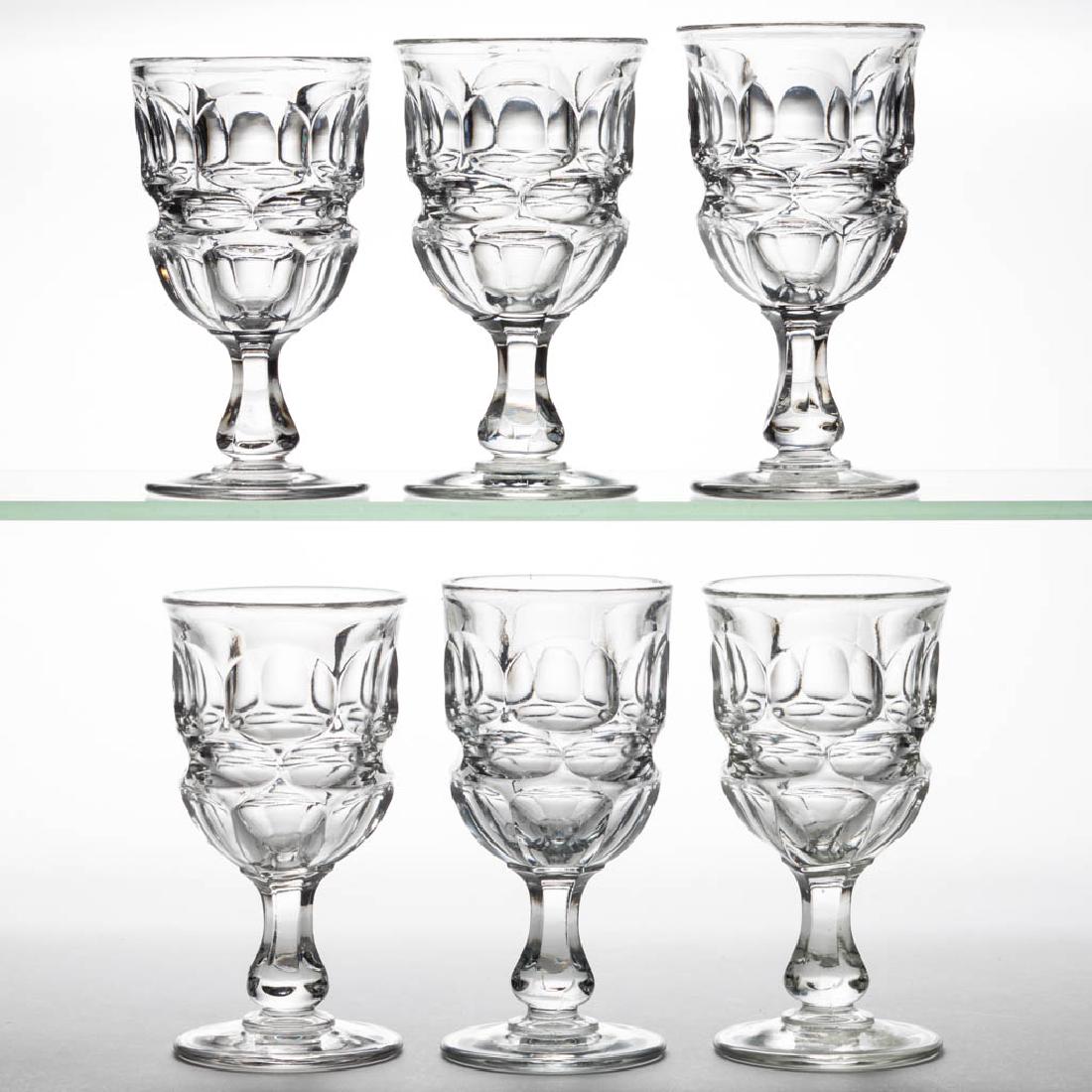 ARGUS CHAMPAGNE GLASSES, SET OF SIX: ARGUS CHAMPAGNE GLASSES, SET OF SIX, colorless lead glass, one example with a polished pontil mark. Third quarter 19th century. 4 7/8" to 5 1/4" H. Undamaged. Provenance: Estate collection of Wagner P