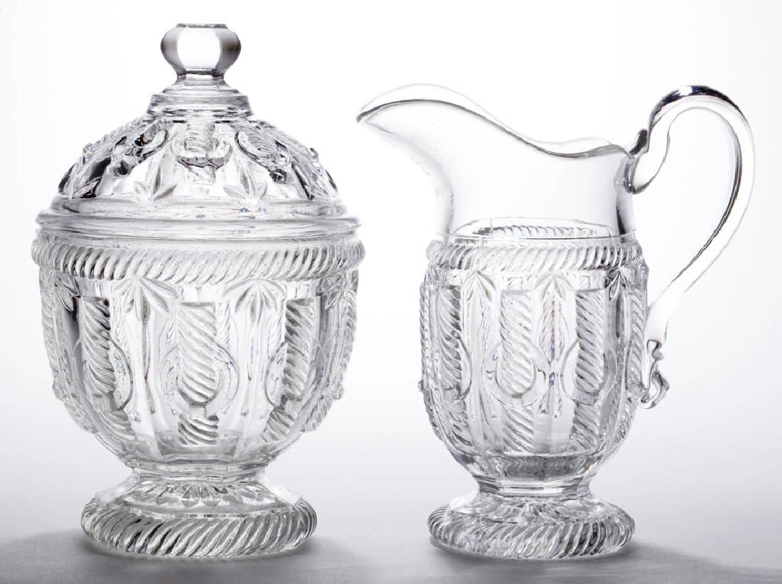 CABLE WITH RING TABLE ARTICLES, LOT OF TWO: CABLE WITH RING TABLE ARTICLES, LOT OF TWO, colorless lead glass, comprising a covered sugar bowl and creamer with applied handle. Third quarter 19th century. 7 1/2" and 6 5/8" HOA. Sugar virtually un