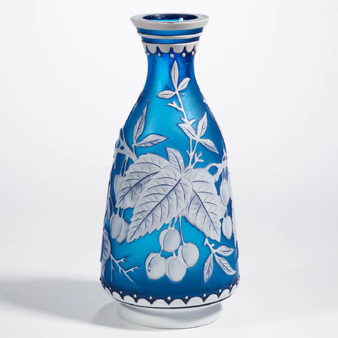 THOMAS WEBB ATTRIBUTED TRI-COLOR CAMEO ART GLASS VASE: THOMAS WEBB ATTRIBUTED TRI-COLOR CAMEO ART GLASS VASE, white to deep blue with an underlying ruby, tall bottle form with cherry decoration, bands to the neck, factory-polished table ring and pontil ma