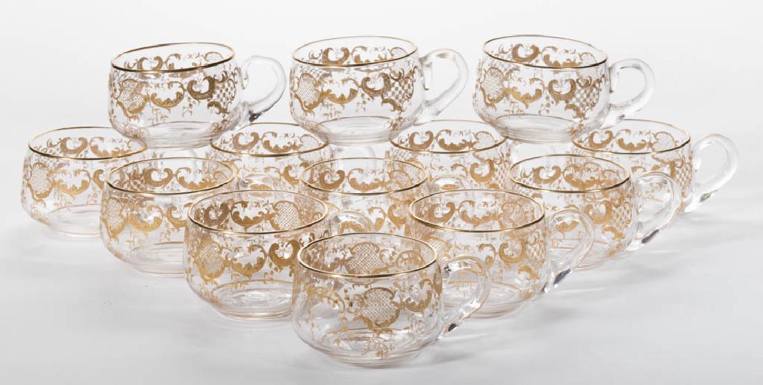 ST. LOUIS GILT DECORATED CUT GLASS PUNCH CUPS, LOT OF: ST. LOUIS GILT DECORATED CUT GLASS PUNCH CUPS, LOT OF 14, colorless lead glass, each with gothic scrolling design and applied handles, each with polished pontil mark. Late 19th/early 20th century. 2" 