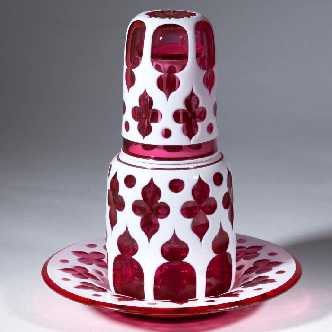 EUROPEAN GOTHIC CUT DOUBLE-OVERLAY TUMBLE-UP AND: EUROPEAN GOTHIC CUT DOUBLE-OVERLAY TUMBLE-UP AND UNDERPLATE, opaque white to cased cranberry with gilt decoration, each with a matching pattern incorporating stylized quatrefoils and punty cuts, tumbl