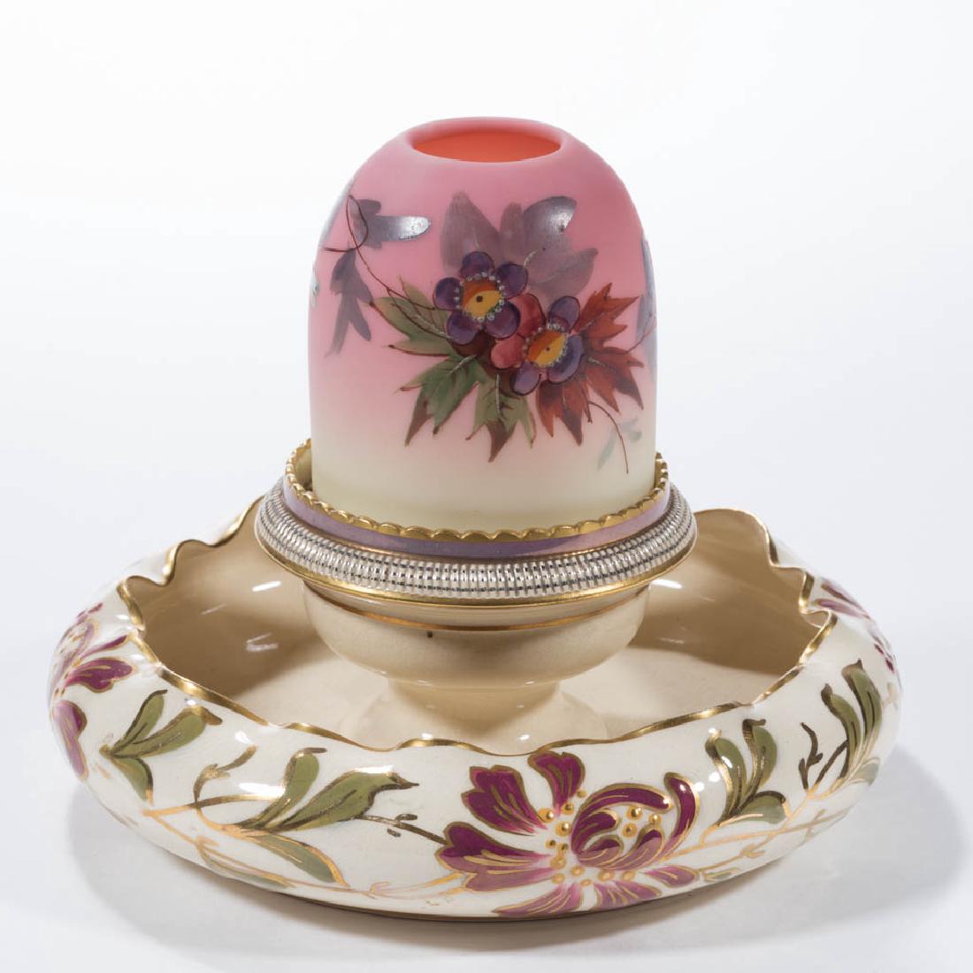 WEBB BURMESE GLASS AND CERAMIC FAIRY LAMP: WEBB BURMESE GLASS AND CERAMIC FAIRY LAMP, satin pyramid shade with Prunus pattern, fitted on a ceramic lamp cup marked "S. CLARKE'S PATENT TRADE MARK FAIRY PYRAMID", integral flower-bowl creamware ba