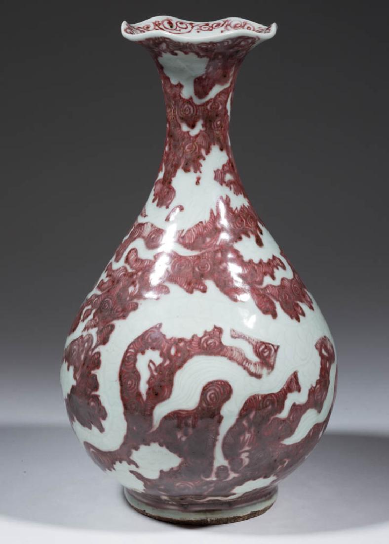 CHINESE EXPORT DRAGON PORCELAIN YUHUCHUN VASE: CHINESE EXPORT DRAGON PORCELAIN YUHUCHUN VASE, having an incised design of a dragon on the sides, with deep red painted decoration, high narrow neck and flared ruffled rim. Unmarked. Ming Dynasty or l