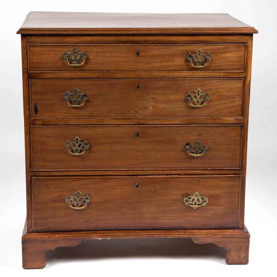 GEORGIAN MAHOGANY BUREAU / CHEST OF DRAWERS: GEORGIAN MAHOGANY BUREAU / CHEST OF DRAWERS, diminutive form, the rectangular top with applied edge molding over four cockbeaded drawers graduated in size, raise on an applied cut-out bracket-foot bas