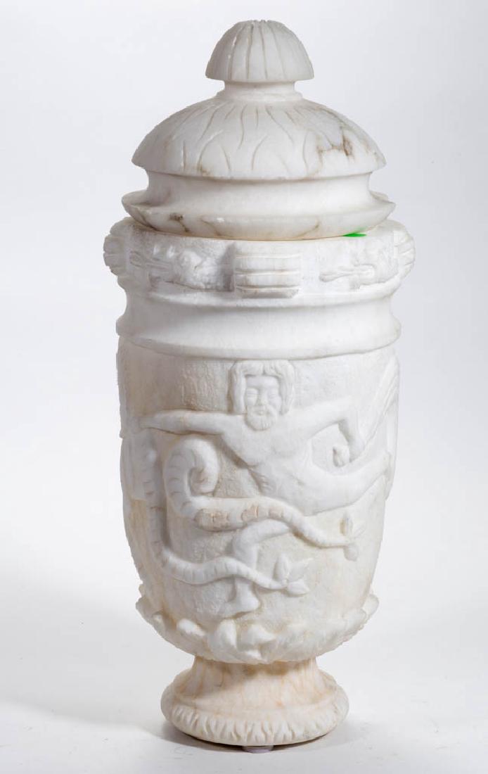 NEOCLASSICAL-STYLE CARVED ALABASTER COVERED URN: NEOCLASSICAL-STYLE CARVED ALABASTER COVERED URN, fantastical decoration featuring nude male figure and seahorses, no markings located. Late 19th/early 20th century. 22" HOA (with cover). Scattered min