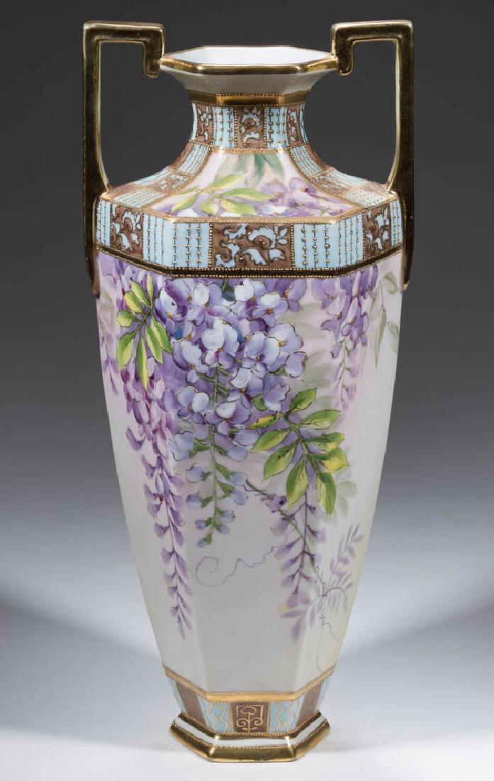 NIPPON PORCELAIN WISTERIA VASE: NIPPON PORCELAIN WISTERIA VASE, having paneled sides, high squared handles, and flared foot, with hand-painted polychrome wisteria floral design on sides; alternating blue and brown rectangles with gi