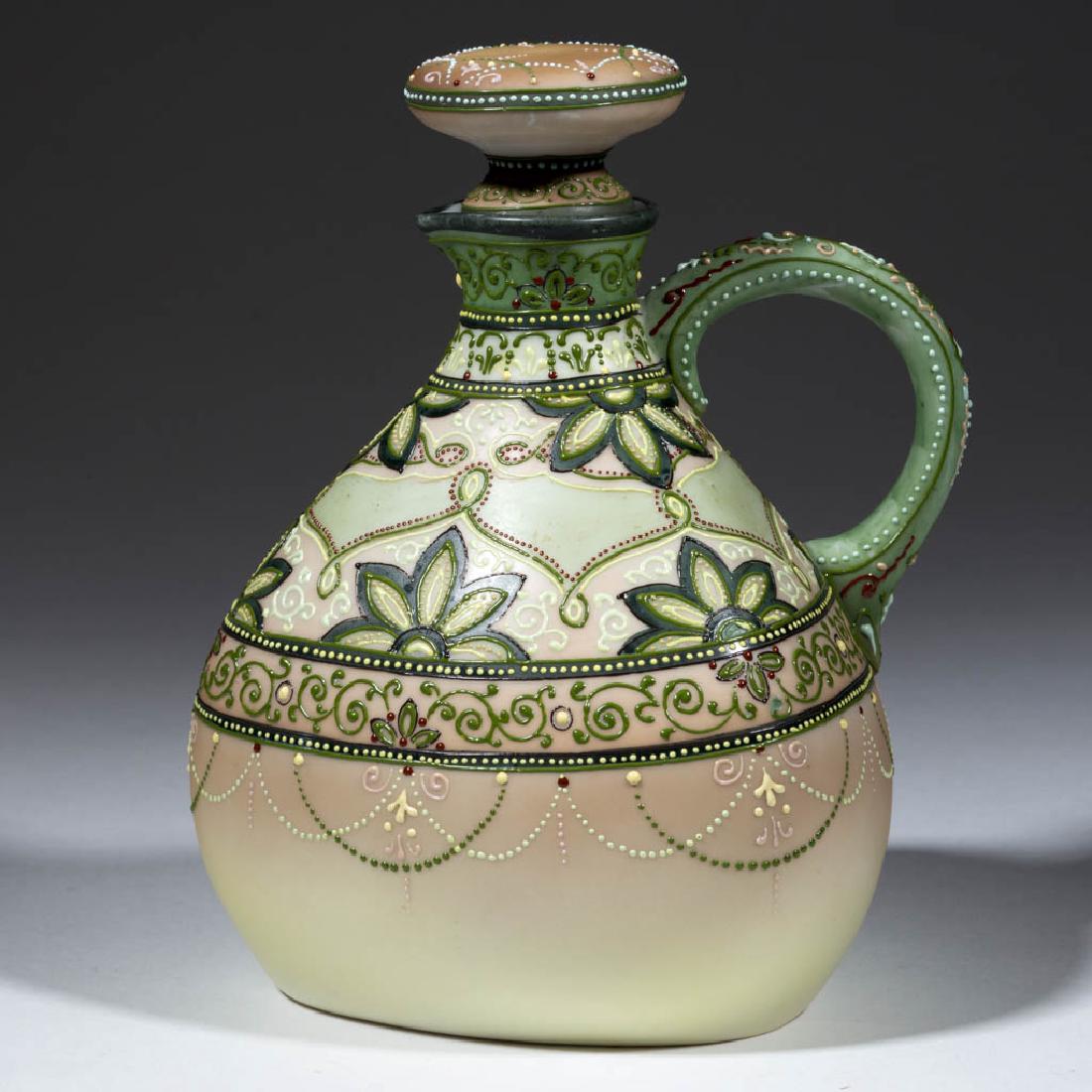 NIPPON PORCELAIN MORIAGE EWER / WINE JUG: NIPPON PORCELAIN MORIAGE EWER / WINE JUG, wide base and narrow neck with one loop handle, ornate floral and geometric polychrome moriage design over variegated ground. Blue maple leaf and "Hand / Pain